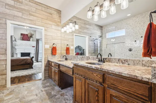 a spacious en suite bathroom with a double vanity sink and a mirror
