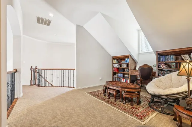 a living room with chairs and a table