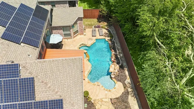 an aerial view of residential houses with outdoor space