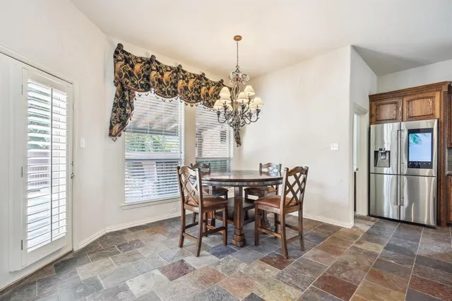 a view of a dining room with furniture and chandelier