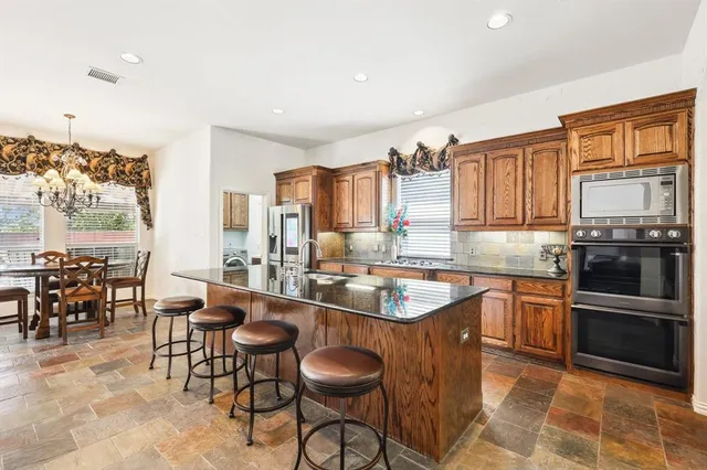 a kitchen with granite countertop a sink and appliances