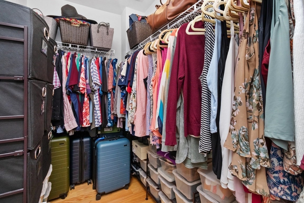 29 Spruce Street, Unit 23 Waltham, MA 02453 - Photo 22 of 26 a view of walk in closet with clothes and shoes