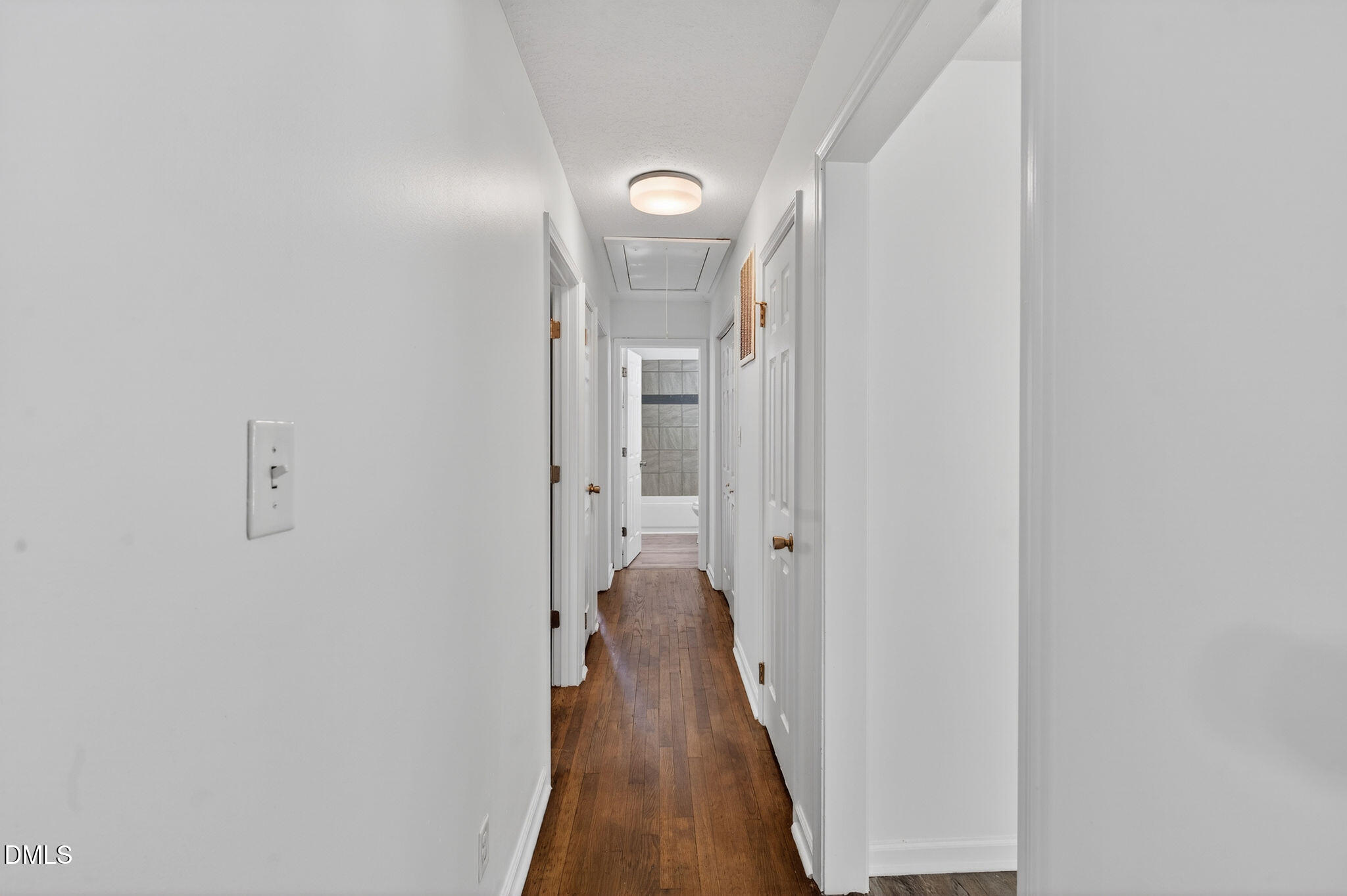 904 Seabrook Road Raleigh, NC 27610 - Photo 15 of 31 a view of a hallway with a livingroom and a bathroom with sink