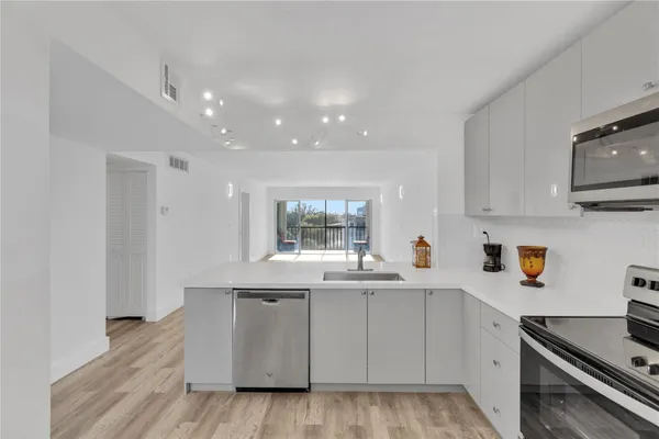 a kitchen with a sink stove and cabinets