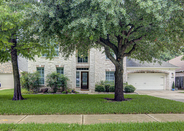 507 Rummel Ranch Run Cedar Park, TX 78613 - Photo 1 of 39 A classic brick and stone facade welcomes with mature trees framing the entry and a double garage.