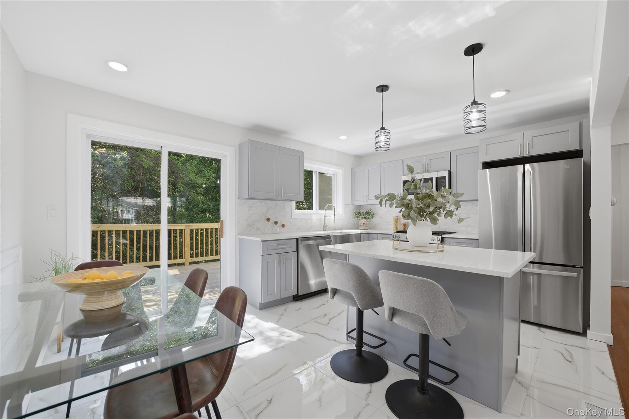 24 Fuller Road Ossining, NY 10562 - Photo 10 of 48 a kitchen with a dining table chairs refrigerator and cabinets