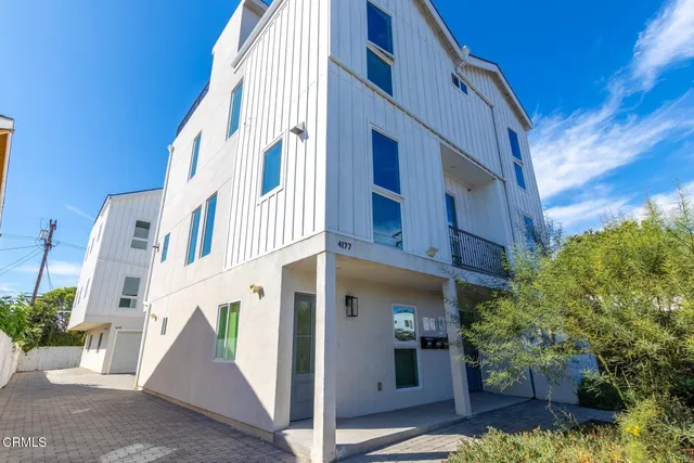 a view of a large building with potted plants