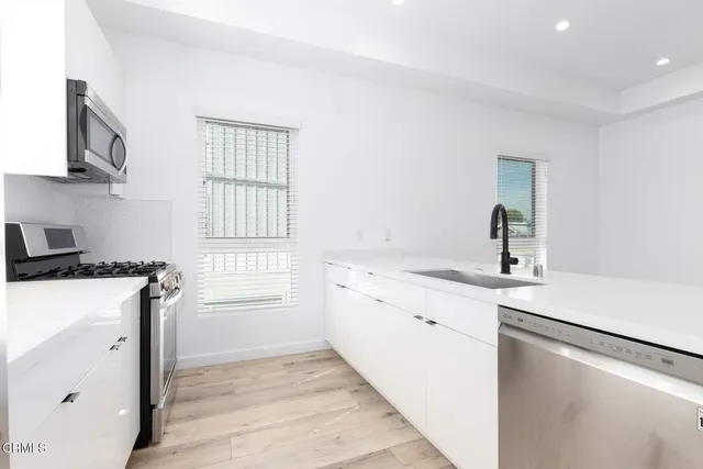 a kitchen with a sink stove and refrigerator