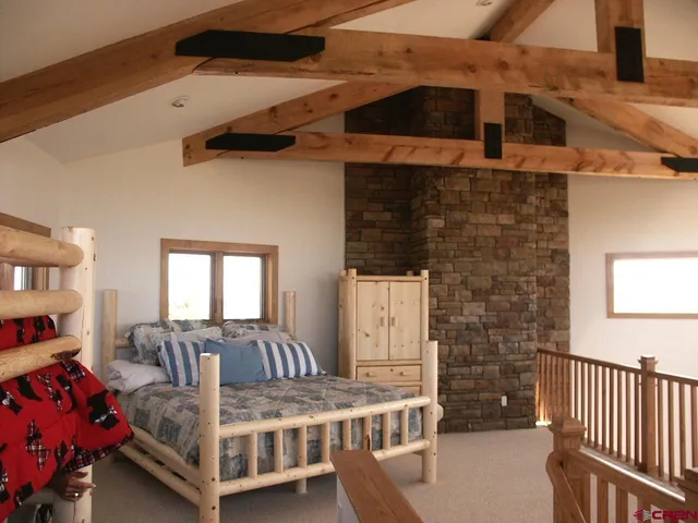 a bedroom with a bed and a fireplace