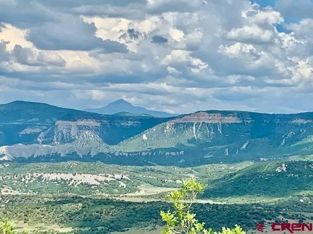 a view of a mountain with mountains in the background