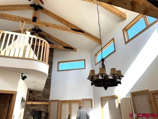 a dining room with furniture and a large window