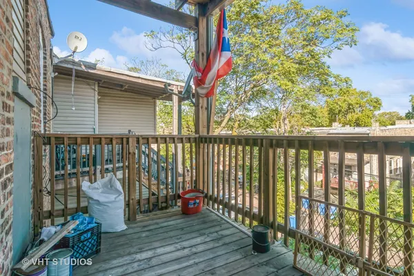 a view of a balcony with chair and wooden floor