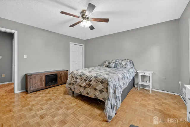 a bedroom with a bed and a ceiling fan