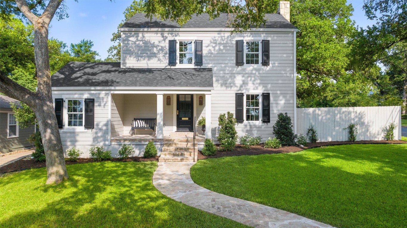 a front view of a house with a yard and porch