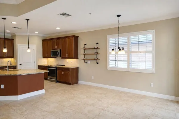 a dining room with furniture a chandelier and a window