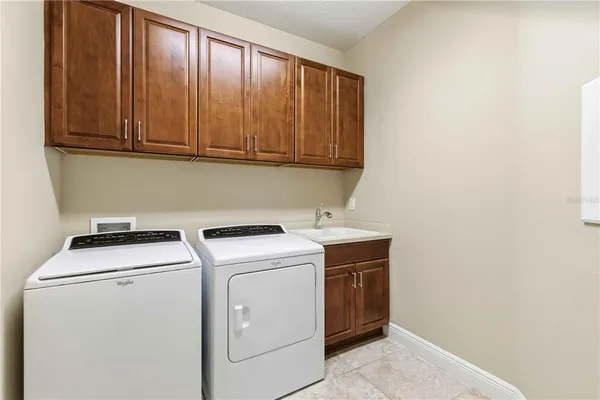 a view of backyard with a potted plant and floor to ceiling window