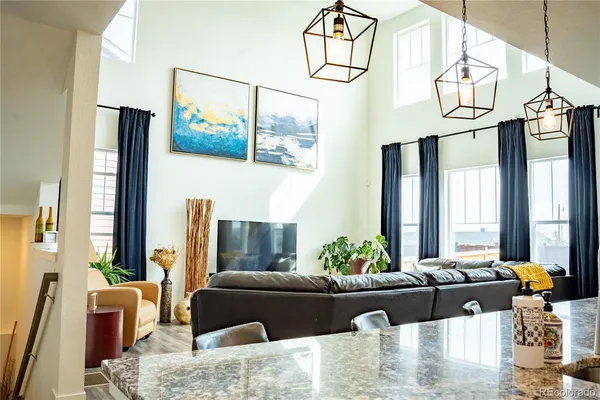 a living room with furniture flowerpot and a window