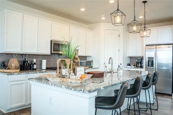 a kitchen with sink a microwave and cabinets