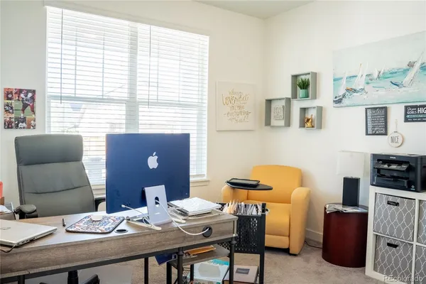 a view of a dining room with furniture and window