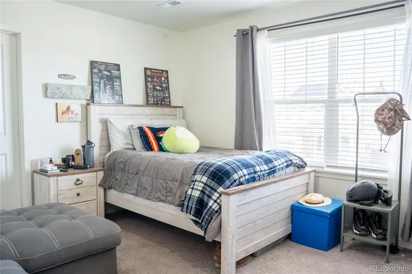 a bedroom with a bed and a chair