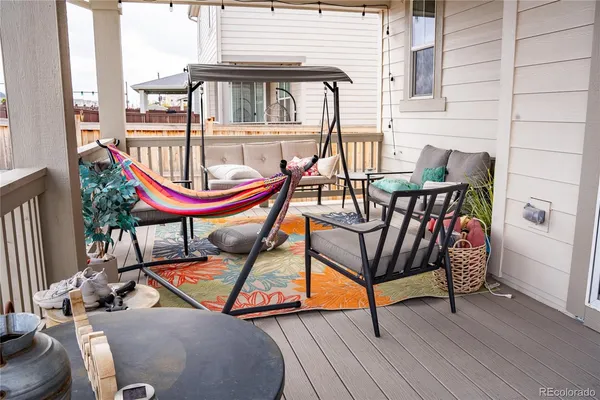 a backyard of a house with barbeque oven table and chairs