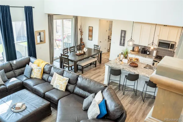 a living room with furniture fireplace and a large window