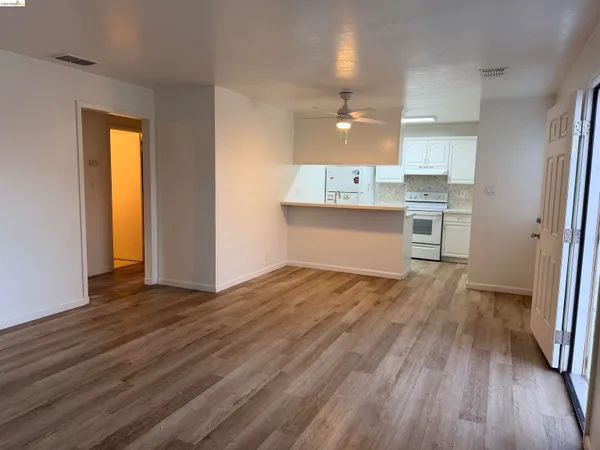 a view of a kitchen with wooden floor and a sink