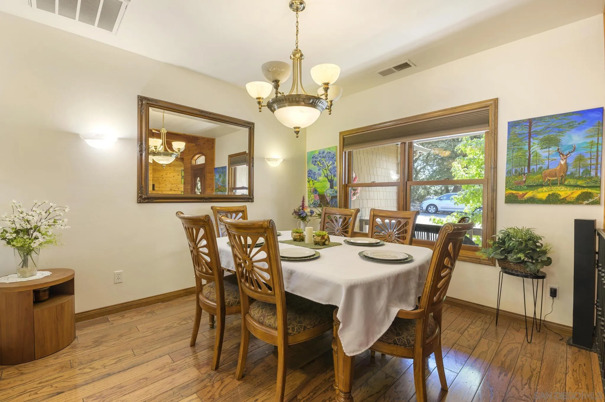 34610 Apache Drive Julian, CA 92036 - Photo 6 of 23 a dining room with wooden floor a chandelier a wooden table and chairs