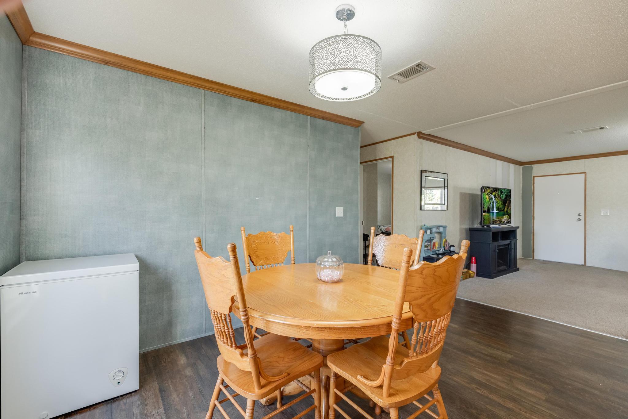 960 State Line Road DeFuniak Springs, FL 32433 - Photo 17 of 51 a view of a dining room with furniture and wooden floor