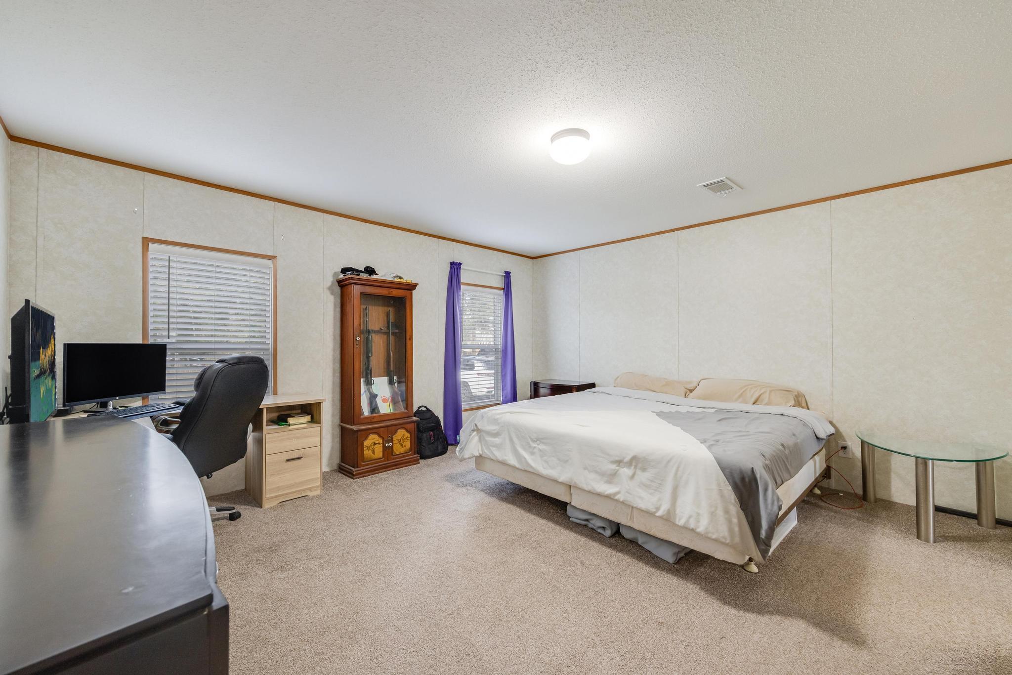 960 State Line Road DeFuniak Springs, FL 32433 - Photo 18 of 51 a bedroom with a bed and wooden furniture