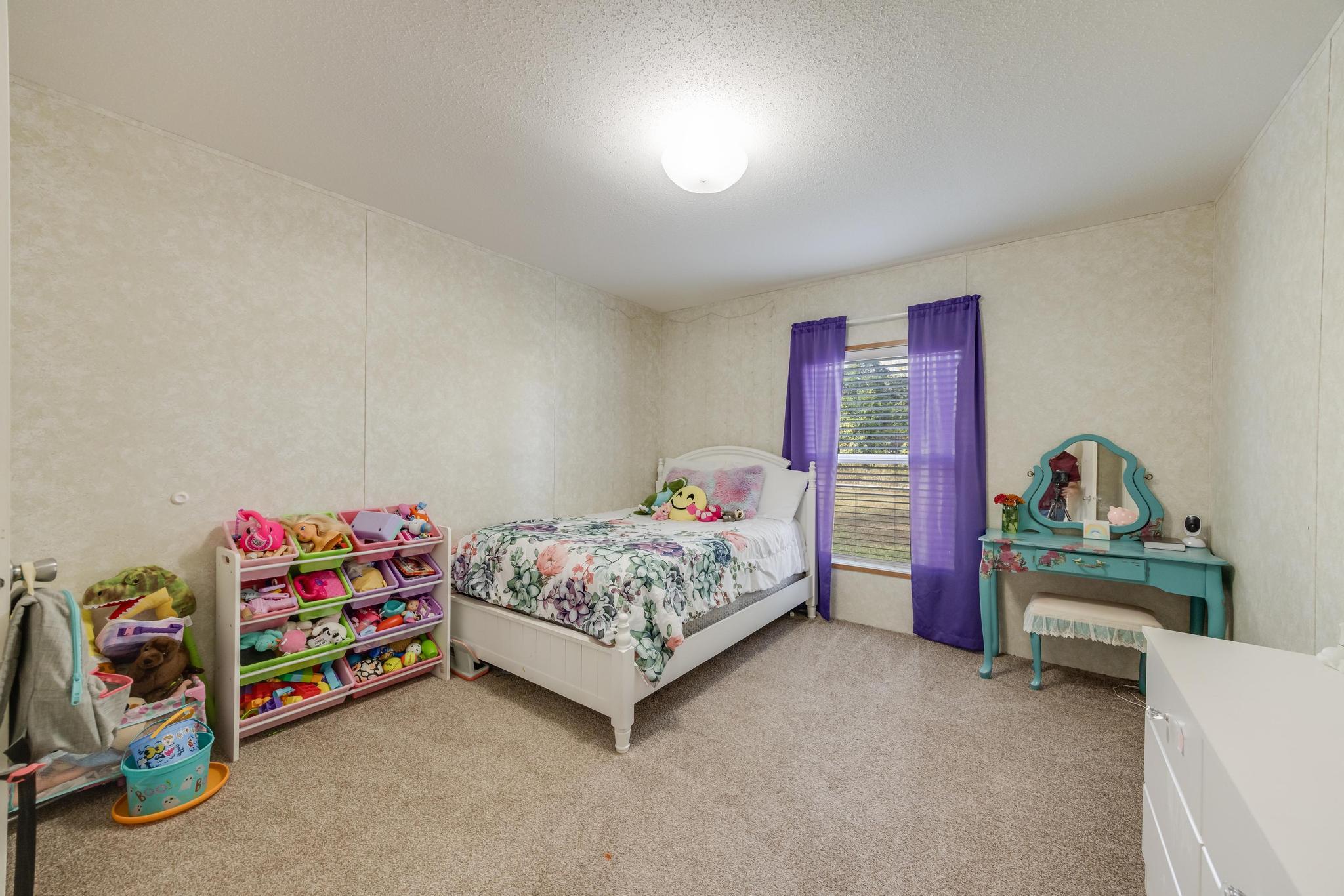 960 State Line Road DeFuniak Springs, FL 32433 - Photo 24 of 51 a bedroom with furniture and a wooden floor