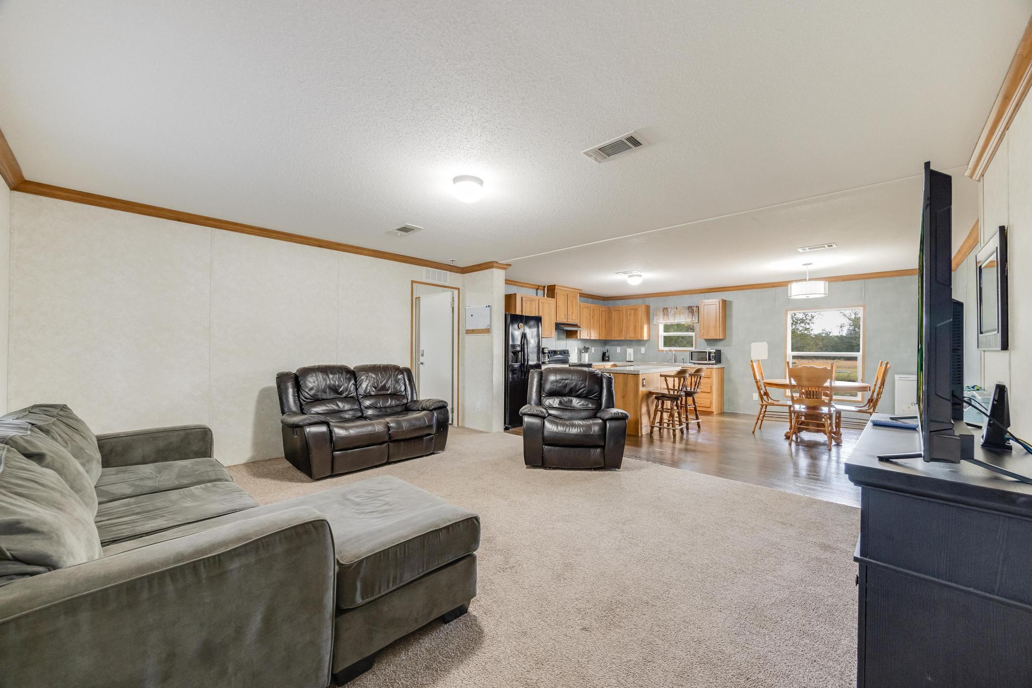 960 State Line Road DeFuniak Springs, FL 32433 - Photo 5 of 51 a living room with furniture and a flat screen tv