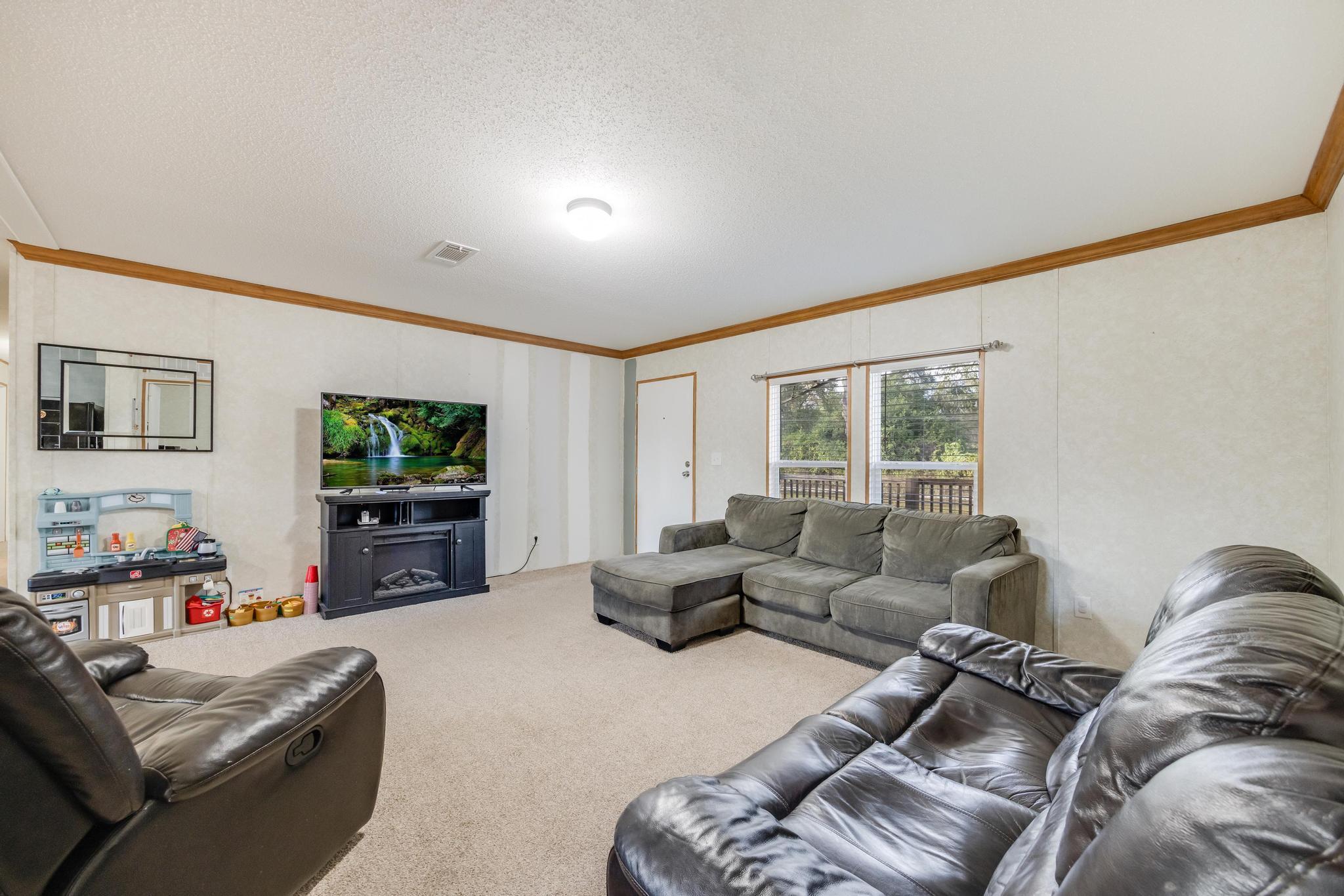 960 State Line Road DeFuniak Springs, FL 32433 - Photo 7 of 51 a living room with furniture and a flat screen tv