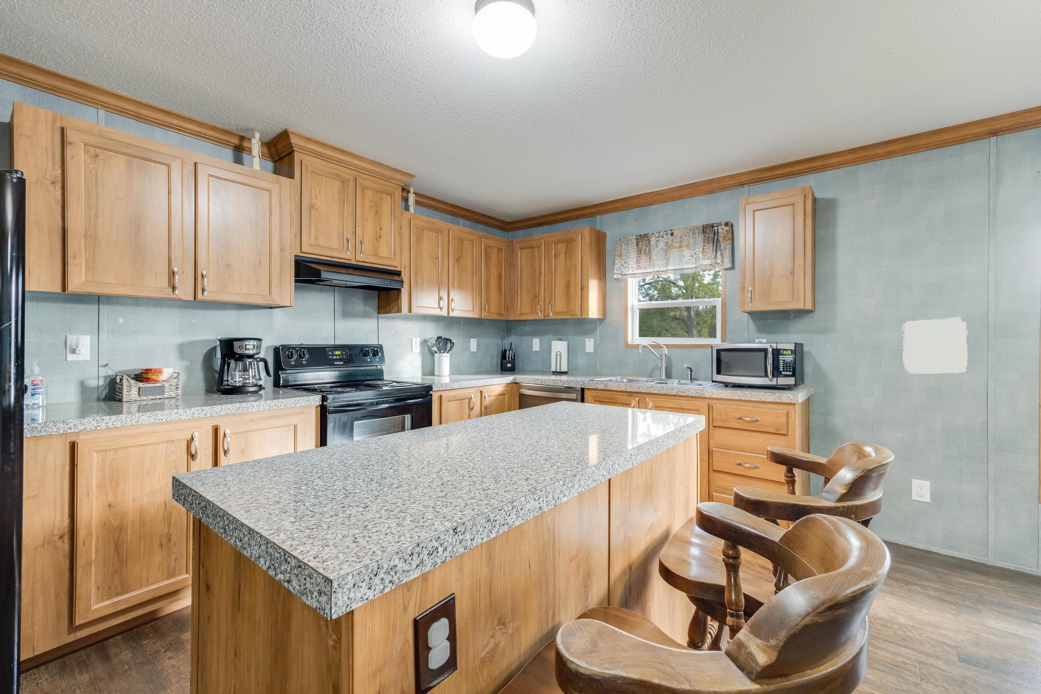 960 State Line Road DeFuniak Springs, FL 32433 - Photo 10 of 51 a kitchen with stainless steel appliances granite countertop a sink dishwasher stove refrigerator and cabinets