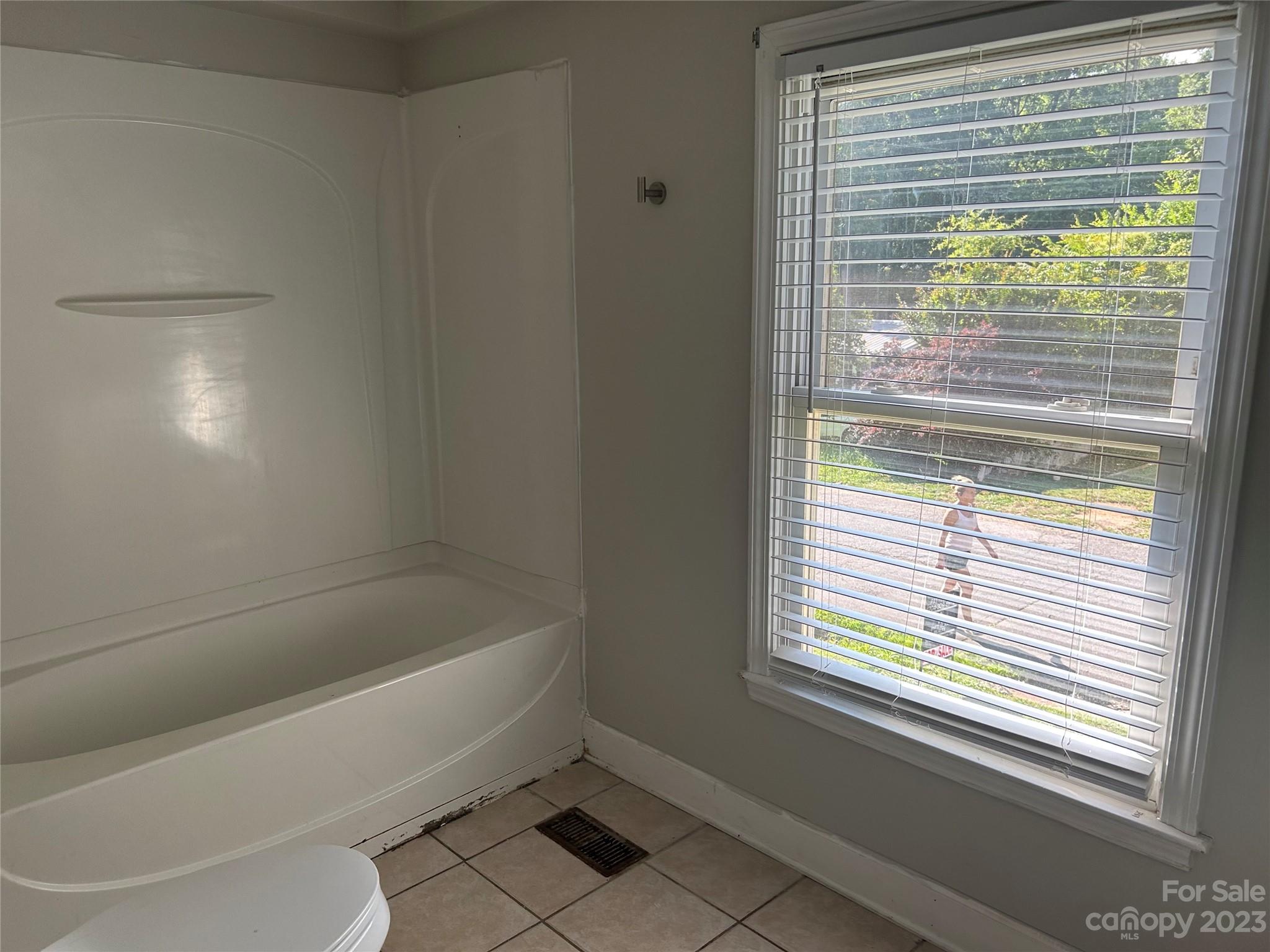 211 Calhoun Street Fort Mill, SC 29715 - Photo 8 of 13 a bathroom with a bathtub and next to a window