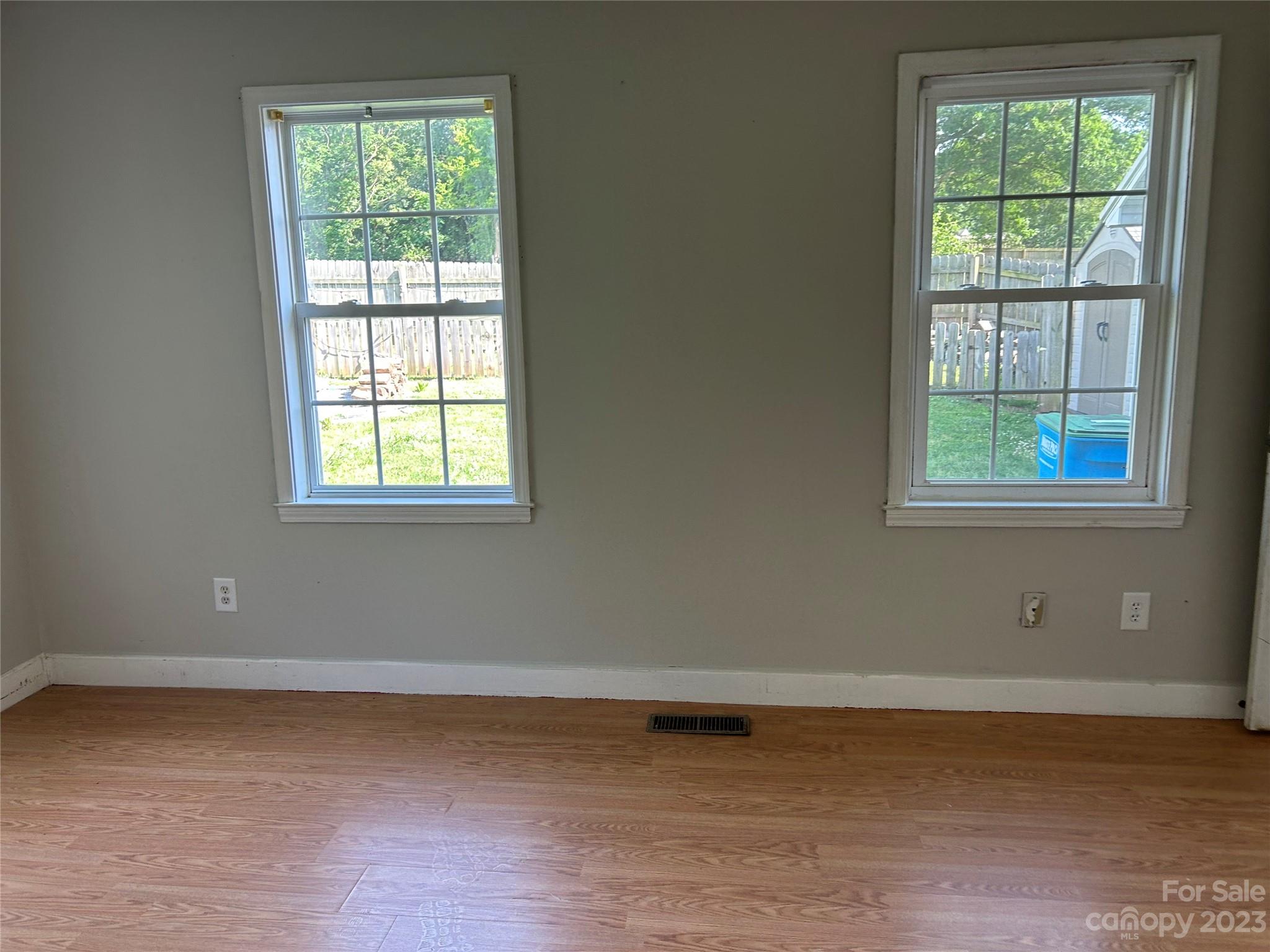 211 Calhoun Street Fort Mill, SC 29715 - Photo 9 of 13 an empty room with wooden floor and windows