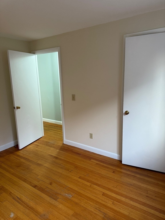 39 Linden Street, Unit 21 Boston, MA 02134 - Photo 12 of 20 a view of an empty room with wooden floor