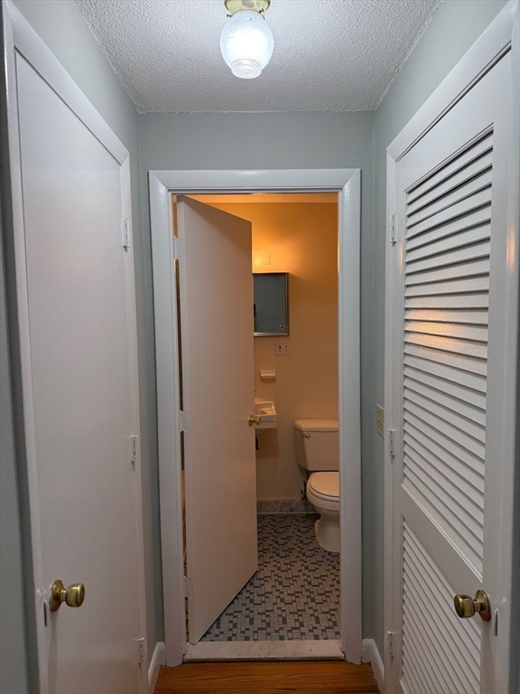 39 Linden Street, Unit 21 Boston, MA 02134 - Photo 5 of 20 a bathroom with a granite countertop toilet and a shower