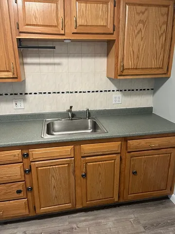 a kitchen with granite countertop cabinets and white appliances