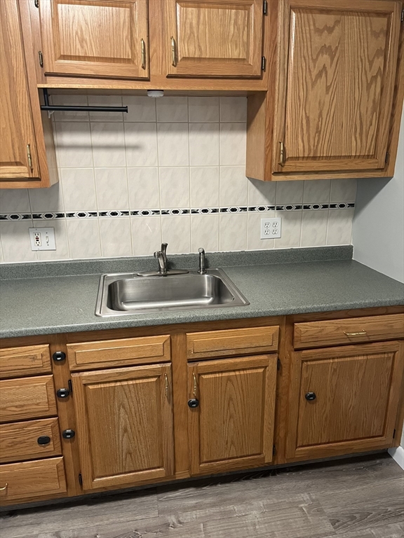 39 Linden Street, Unit 21 Boston, MA 02134 - Photo 10 of 20 a kitchen with granite countertop cabinets and white appliances