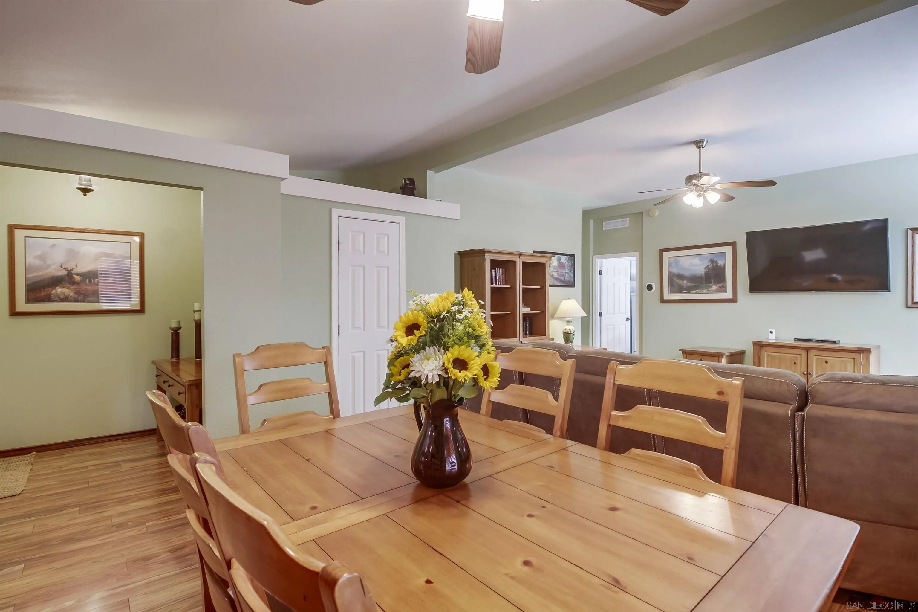 15935 Spring Oaks Road El Cajon, CA 92021 - Photo 14 of 66 a living room with furniture a chandelier and a flat screen tv
