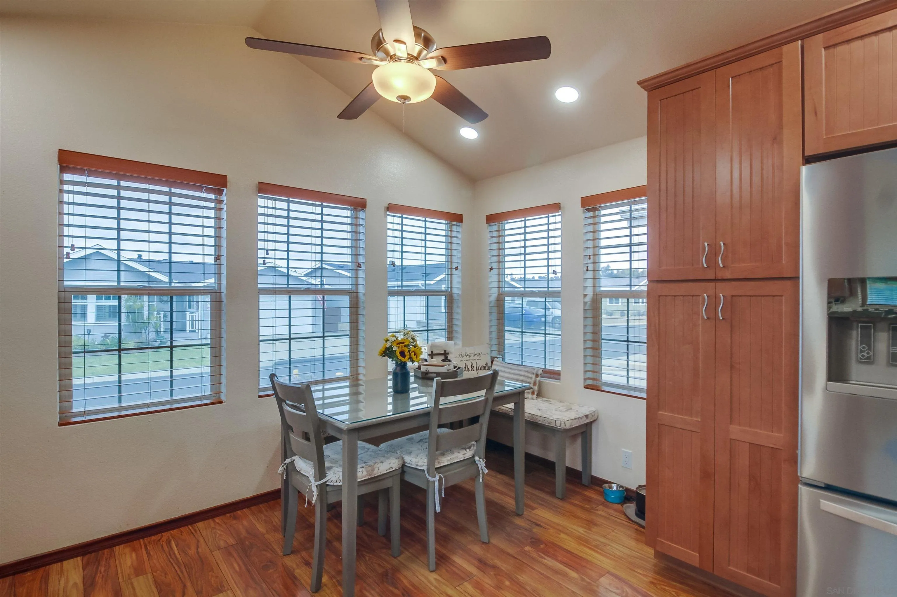 15935 Spring Oaks Road El Cajon, CA 92021 - Photo 18 of 66 a dining room with furniture a chandelier and wooden floor