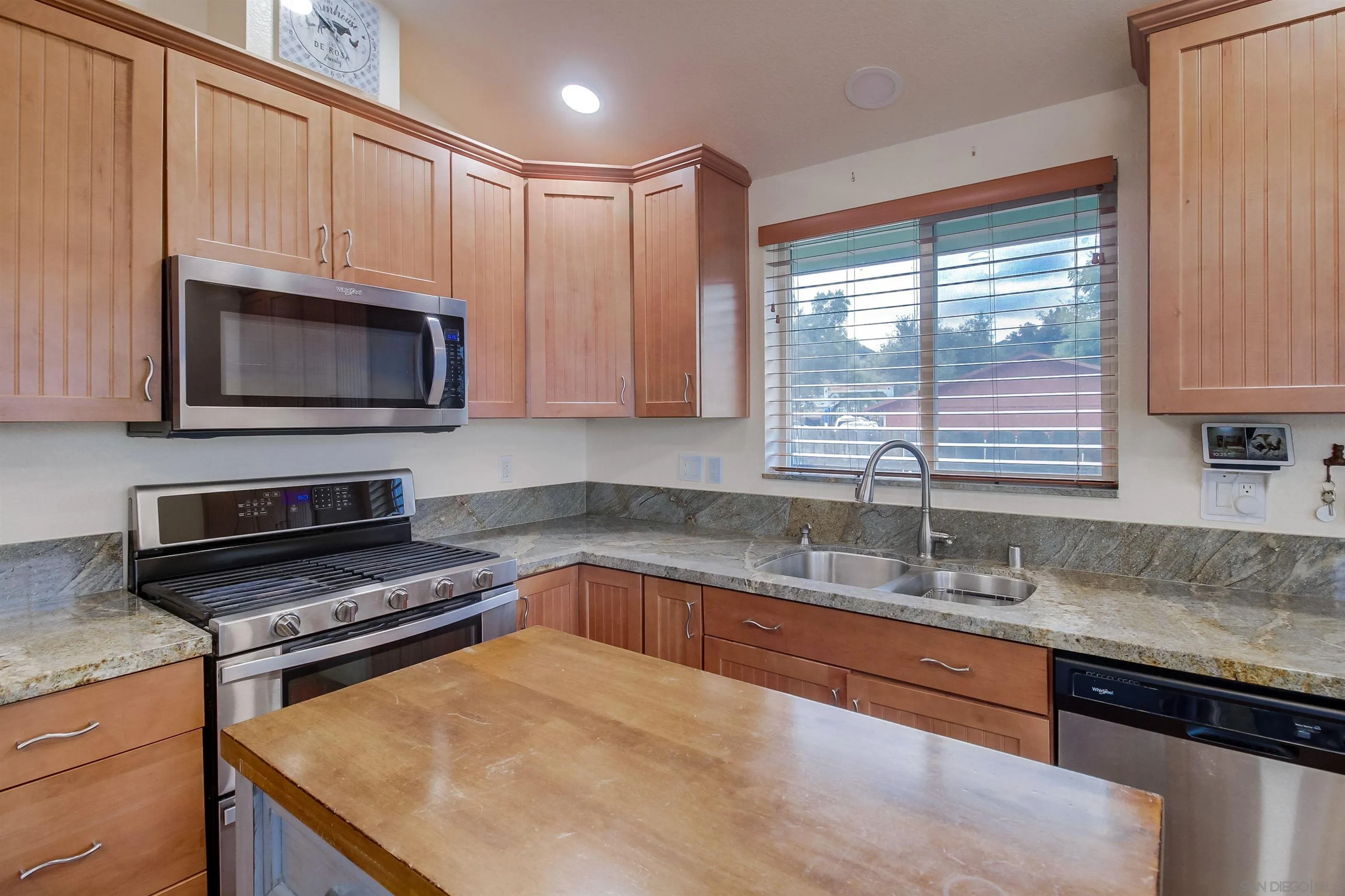 15935 Spring Oaks Road El Cajon, CA 92021 - Photo 22 of 66 a kitchen with granite countertop a sink a stove microwave and cabinets