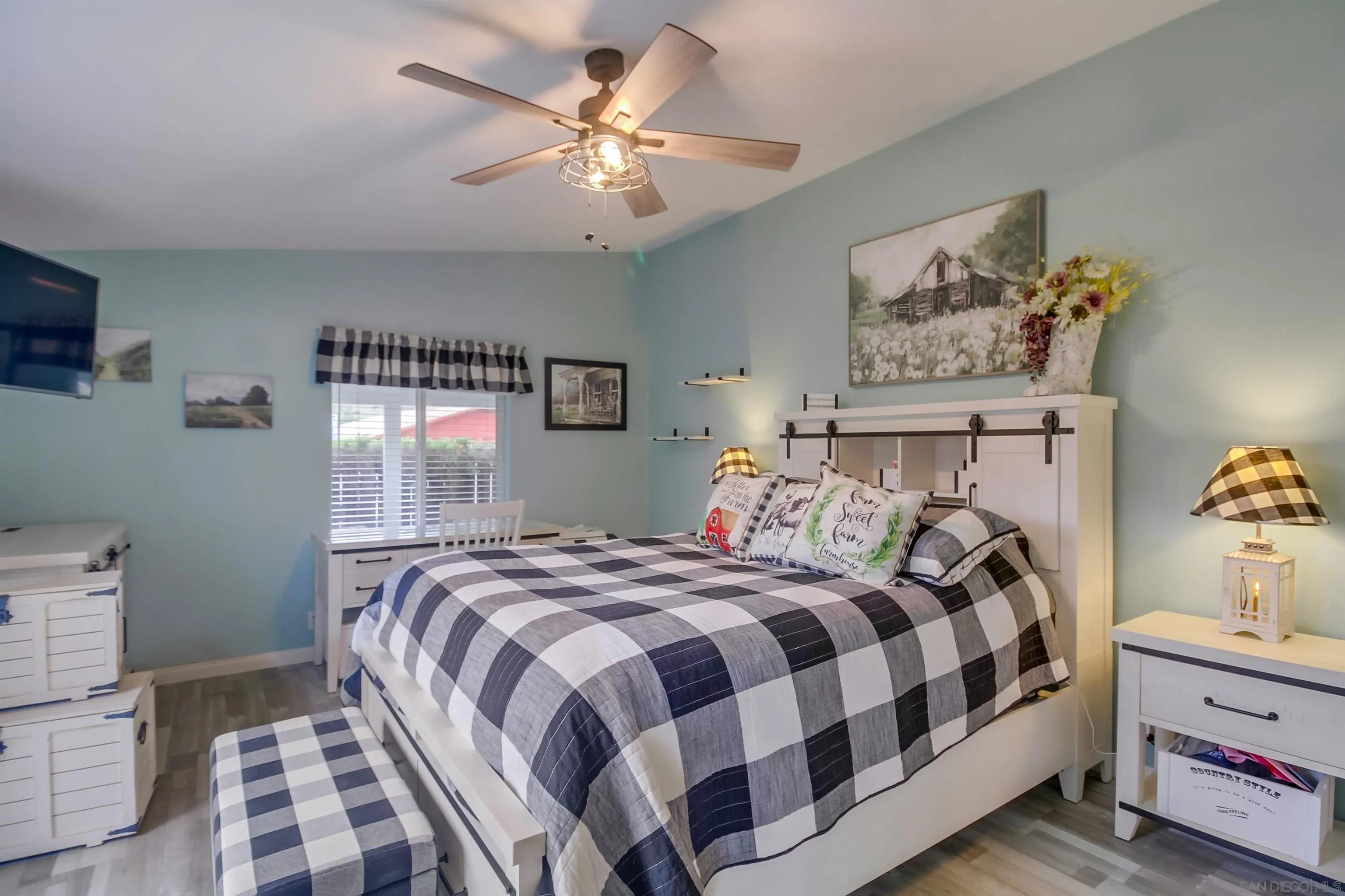 15935 Spring Oaks Road El Cajon, CA 92021 - Photo 30 of 66 a bedroom with a bed and a chandelier