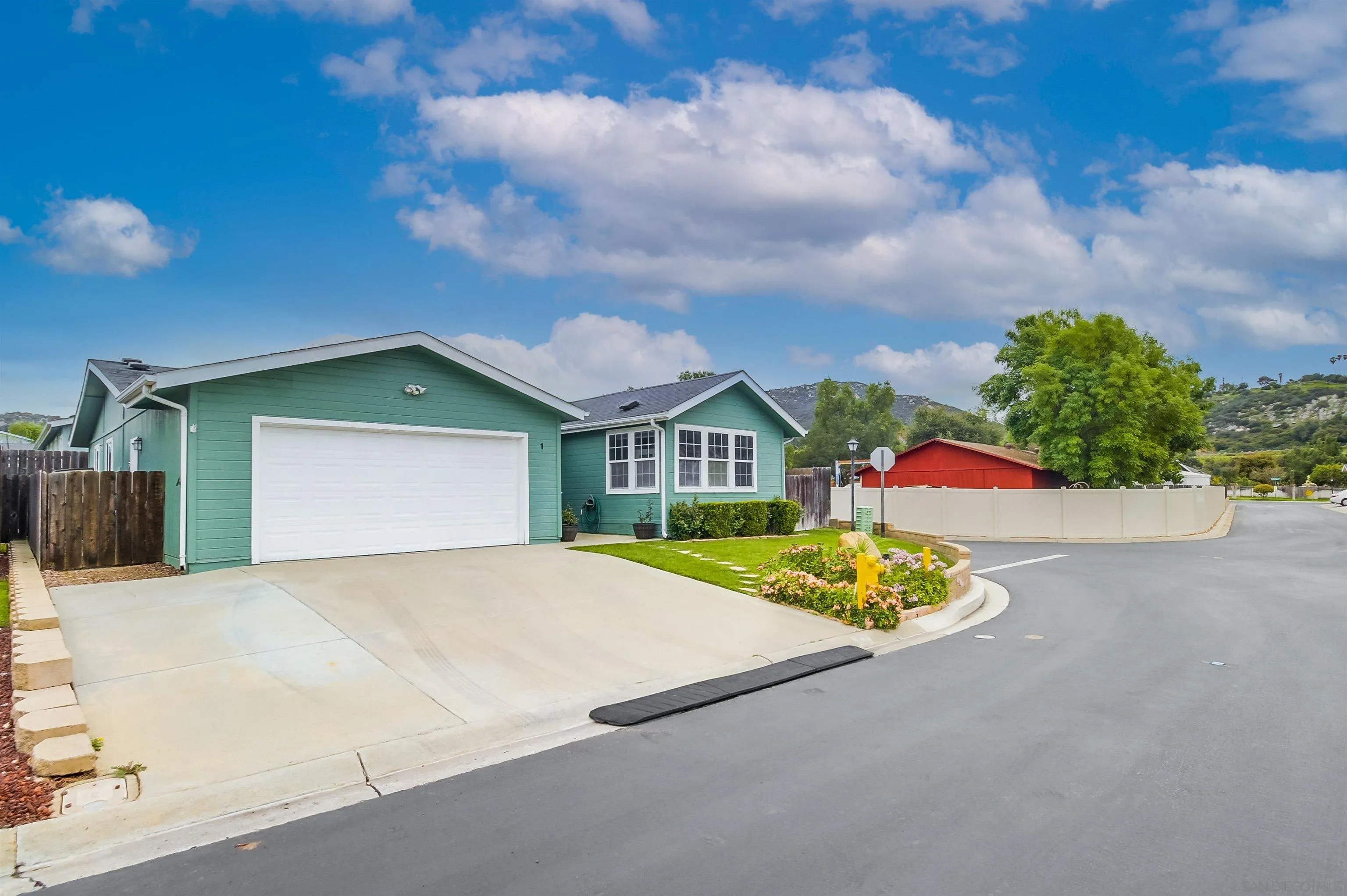 15935 Spring Oaks Road El Cajon, CA 92021 - Photo 3 of 66 a front view of a house with a yard and garage