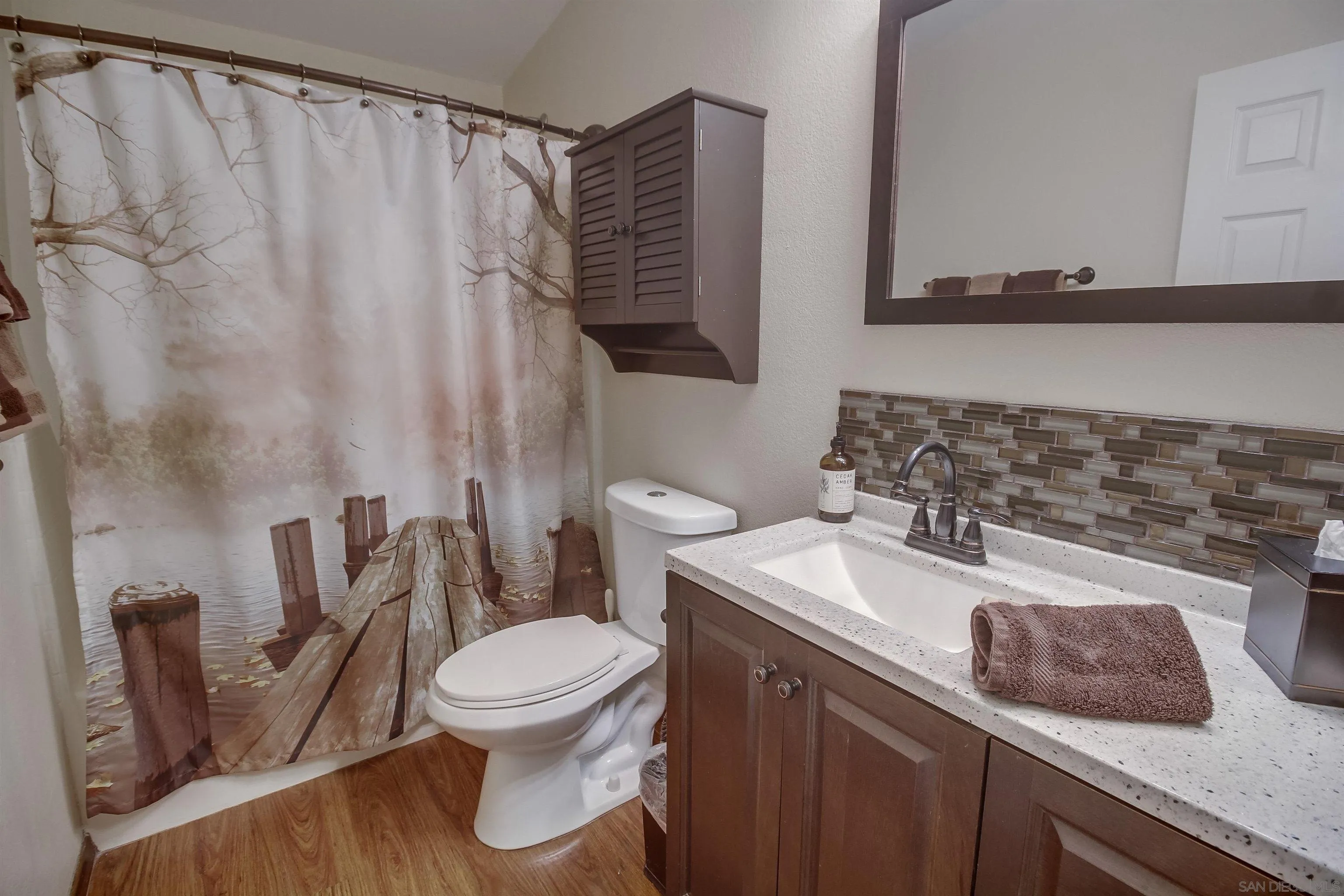 15935 Spring Oaks Road El Cajon, CA 92021 - Photo 38 of 66 a bathroom with a granite countertop sink and a toilet