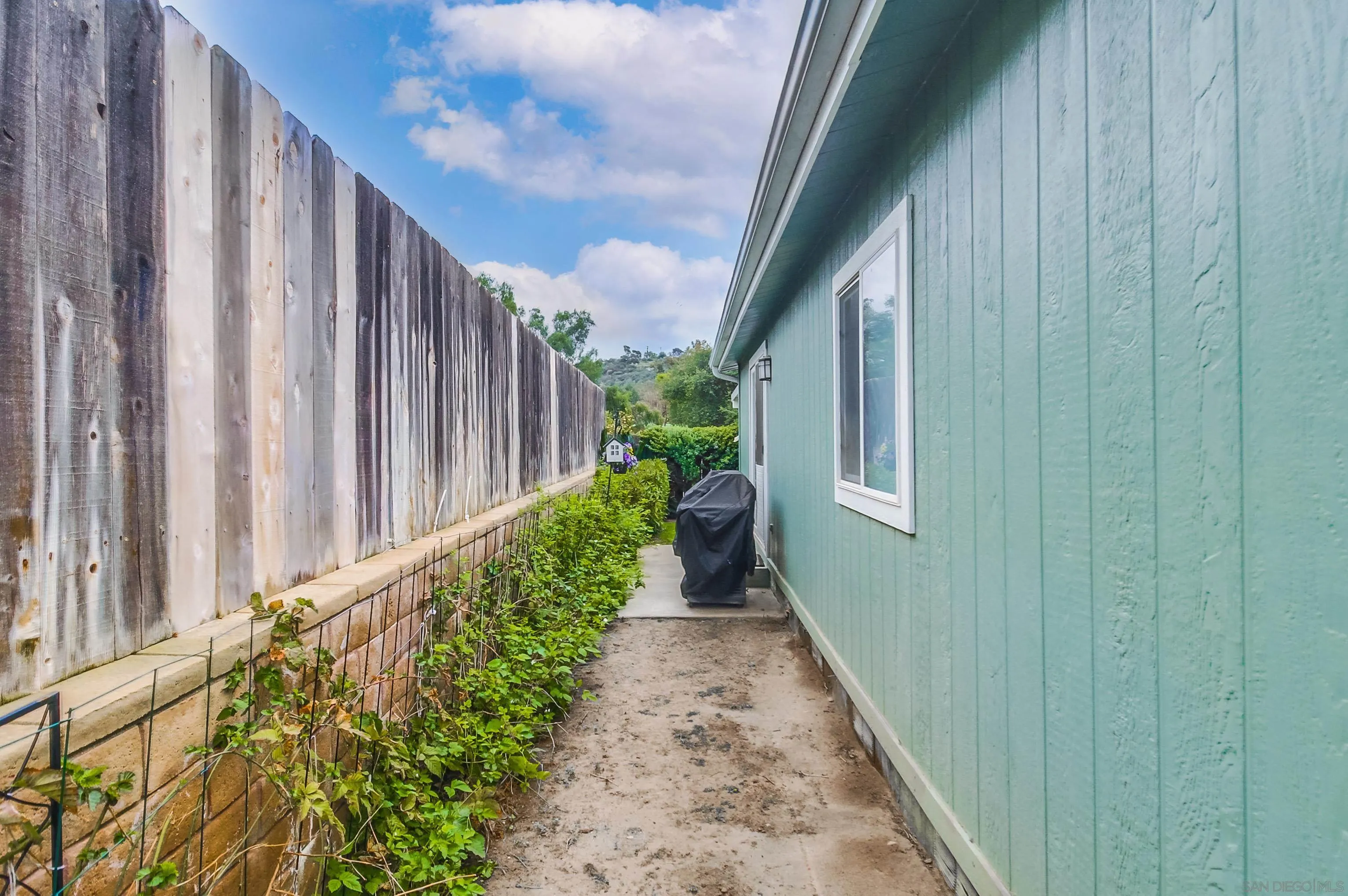 15935 Spring Oaks Road El Cajon, CA 92021 - Photo 51 of 66 a view of a pathway of a wooden fence