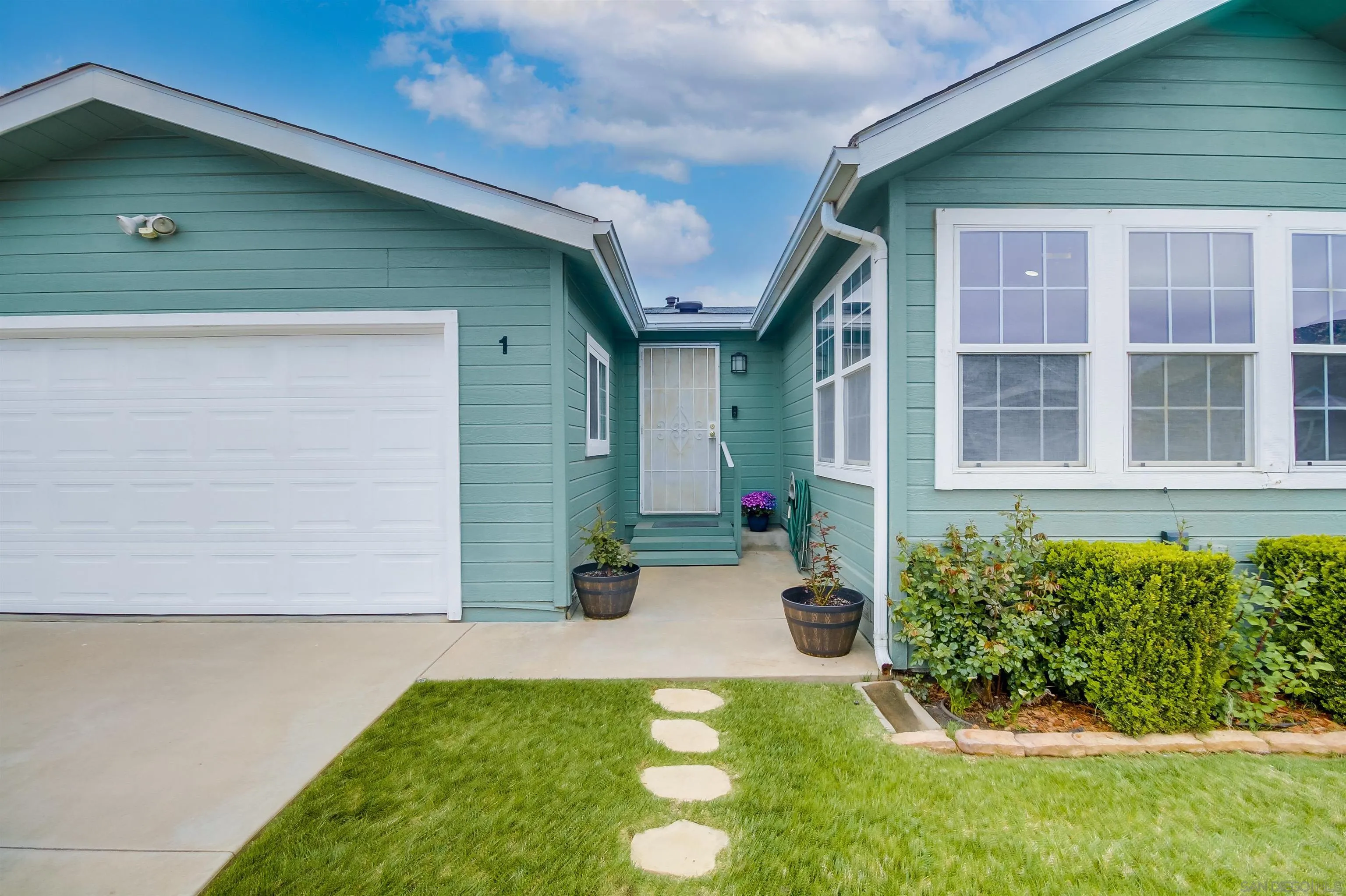 15935 Spring Oaks Road El Cajon, CA 92021 - Photo 7 of 66 a front view of a house with a yard