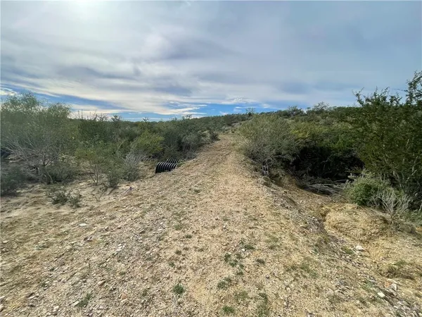 an aerial view of house with yard and lake view