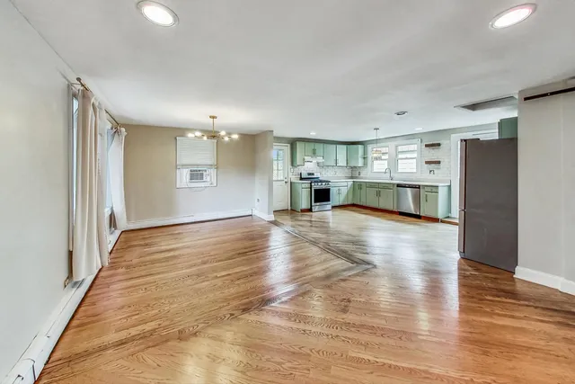 a view of a kitchen with a sink and a refrigerator